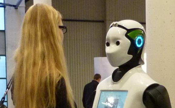 REEM from PAL ROBOTICS interacts with a visitor